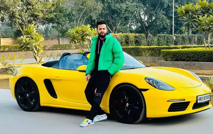 Elvish Yadav with yellow Porsche Boxster convertible