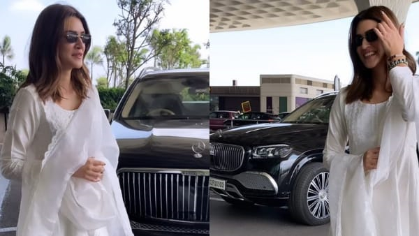 Kriti Sanon standing beside her Audi Q7 car